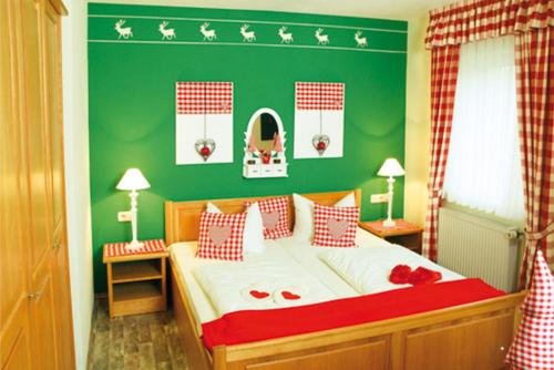 a bedroom with a bed with a green wall at Landhotel Christopherhof in Grafenwiesen