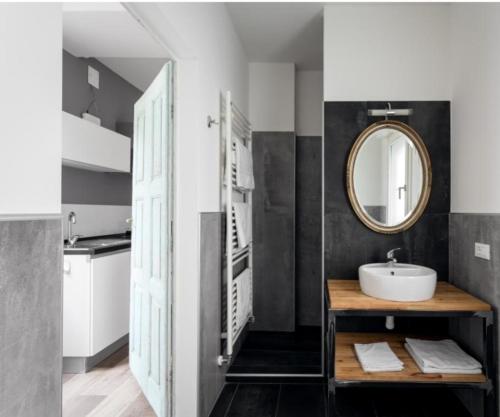 a bathroom with a sink and a mirror at Appartamento Vo' 74 in Trento