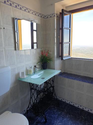 a bathroom with a sink and a toilet at Casa O Arco Alojamento Local in Marvão