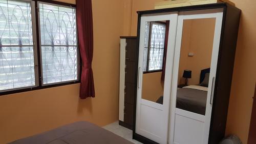 a bedroom with a mirror and a dresser with a bed at La Belle Cliff View in Ao Nang Beach