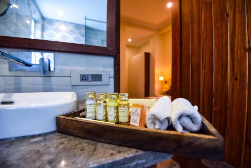 a bathroom with a counter with towels and a sink at Infinitea Tea Garden Resort in Pālampur