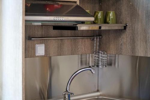 a kitchen sink with a faucet in a kitchen at Agnanti house in Symi