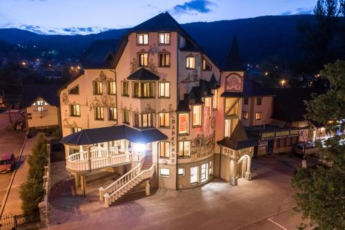 a large building with an umbrella in front of it at Baron SPA Hotel - Museum Yaremche in Yaremche