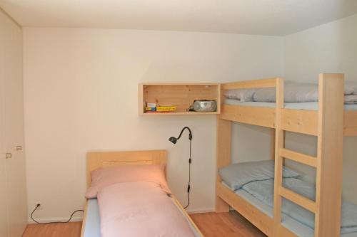 クロスタースにあるMonami Apartments Klosters, Apt. Casa Selva Nr 10のベッドルーム1室(二段ベッド2組、ランプ付)
