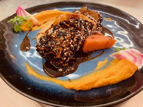 a plate with a piece of cake and chocolate sauce at L'Estirado des Adrets in Les Adrets de l'Esterel