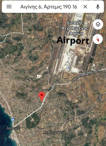 a map of an airport with a red dot at HELEN in Artemida