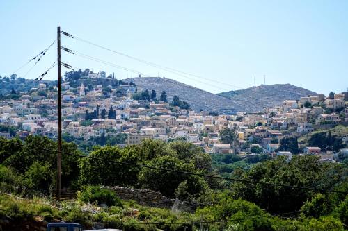 a view of a city with houses on a hill at Agnanti house in Symi
