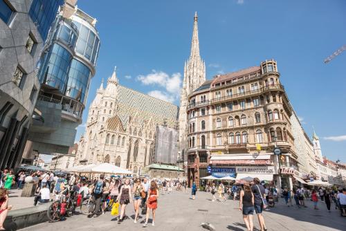 a crowd of people walking in a busy city street at Mint@Naschmarkt Premium Apartments in Vienna