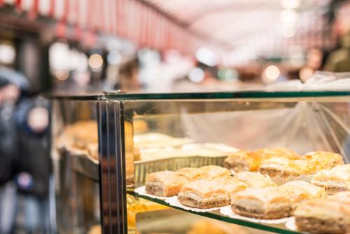 a display case full of donuts in a bakery at Mint@Naschmarkt Premium Apartments in Vienna