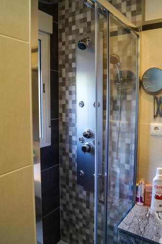 a shower with a glass door in a bathroom at Casa Rural El Nacimiento in Benaoján