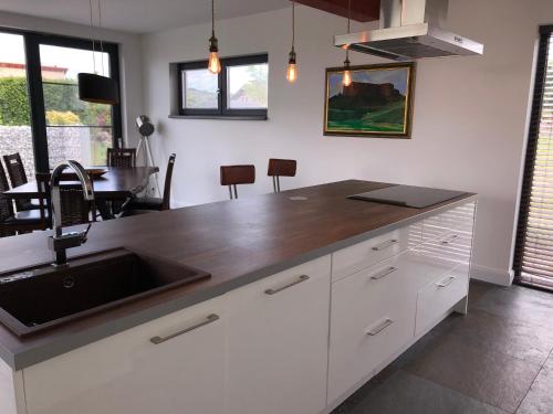 a kitchen with a sink and a counter top at das Haus in Jois in Jois