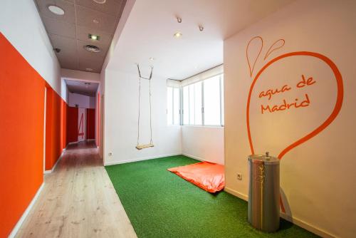 an empty room with an orange and green floor at Safestay Madrid Central in Madrid