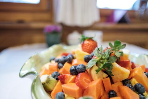 a bowl filled with fruit on a table at Landhaus am Stein in Bad Wiessee