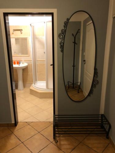 a mirror on a wall in a bathroom at Penzion RETRO in Petrovice
