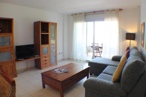 a living room with a couch and a coffee table at Agi Torre Quimeta Apartments in Roses