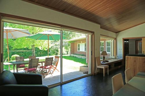 a living room with a table with an umbrella at Casa de Outeiro in Cabeceiras de Basto