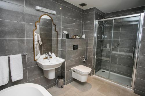 a bathroom with a sink toilet and a shower at Longcourt House Hotel in Newcastle West