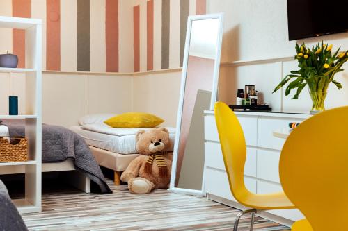 a small bedroom with a teddy bear sitting in the doorway at Hotel Corel in Scheveningen