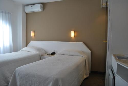 a hotel room with two beds and a window at Hotel Castilla in Punta del Este