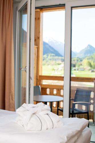 a bedroom with a bed with a view of a mountain at aja Ruhpolding in Ruhpolding