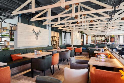 a restaurant with wooden tables and chairs and a menu at aja Ruhpolding in Ruhpolding