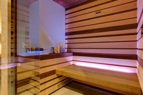 a sauna with a bench in a room at Klima Hotel Milano Fiere in Milan