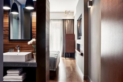 La salle de bains est pourvue d'un lavabo et d'un miroir. dans l'établissement Hotel Achilleas, à Athènes