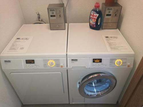 a washer and dryer with two boxes on top of it at St. Florian Appartements in Galtür