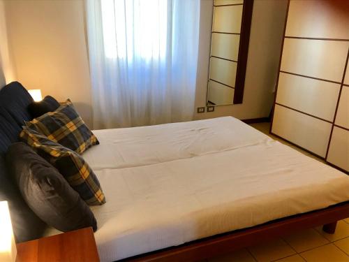 a bedroom with a large bed with a mirror at La Vecchia Caserma in Porlezza