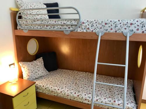 a bedroom with two bunk beds with a ladder at La Vecchia Caserma in Porlezza