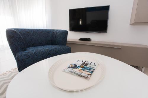 a room with a table and a chair and a tv at blue adria in Primošten
