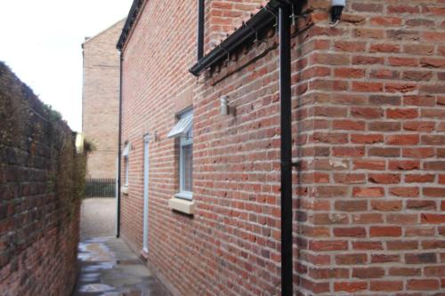 a brick building with a window on the side of it at Georgian House & Mews in York