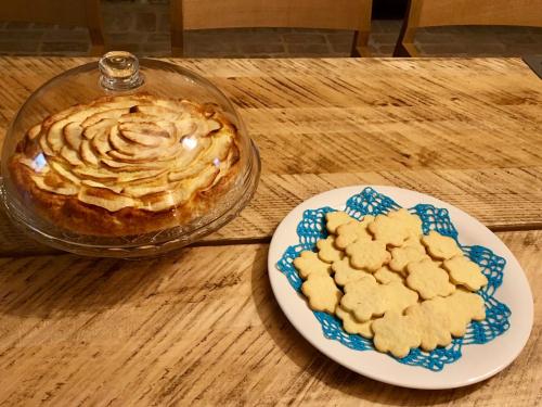 a plate with a pie and cookies on a table at Agr. Cascina Fabbrica in Fossano