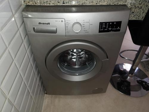 a washer and dryer in the corner of a bathroom at Appartement cocooning à saidia proche toutes commodités in Saidia 