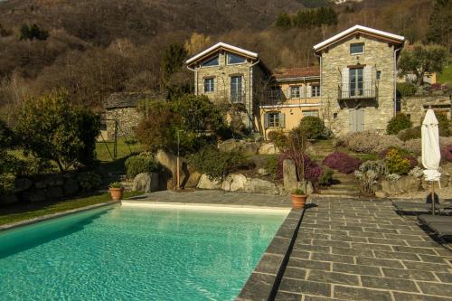 a house with a swimming pool in front of a house at Agriturismo Treterre in Pianello Del Lario