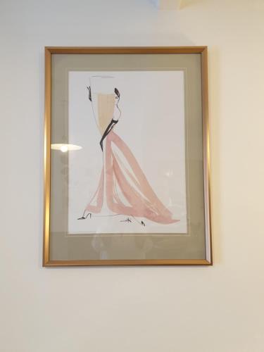 a picture of a dress in a frame on a wall at BlueBells at Plover Cottage Lindley in Huddersfield
