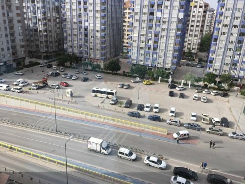 a view of a parking lot with cars and buses at Bera Konya Hotel in Konya