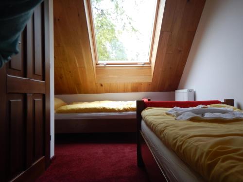 a bedroom with two beds and a window at Domek Dzika Róża in Szklarska Poręba
