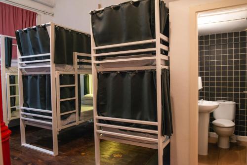 a group of bunk beds in a room with a toilet at Safestay Barcelona Gothic in Barcelona