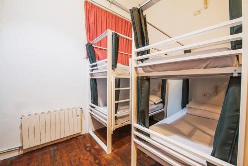 a group of bunk beds in a room at Safestay Barcelona Gothic in Barcelona