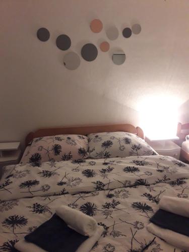 a bedroom with a bed with a comforter and dots on the wall at Nijona 1 in Trebinje
