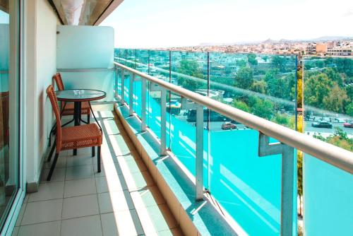 a balcony with a table and a view of a river at Capsis Astoria Heraklion in Heraklio Town