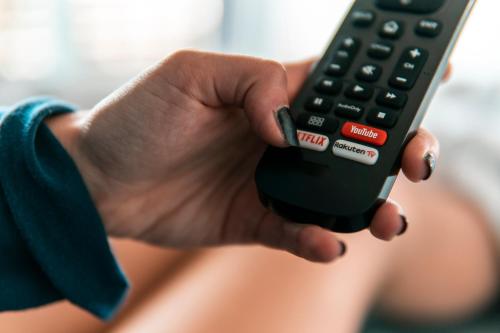 a person holding a remote control in their hand at Alla Riva in Verona