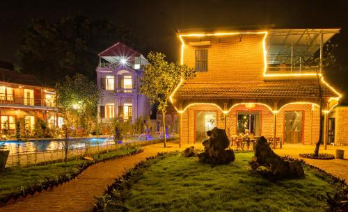 a house with lights on the side of it at night at Ruby Homestay in Ninh Binh