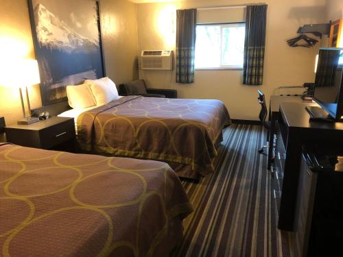 a hotel room with two beds and a window at Super 8 by Wyndham Portland Airport in Portland