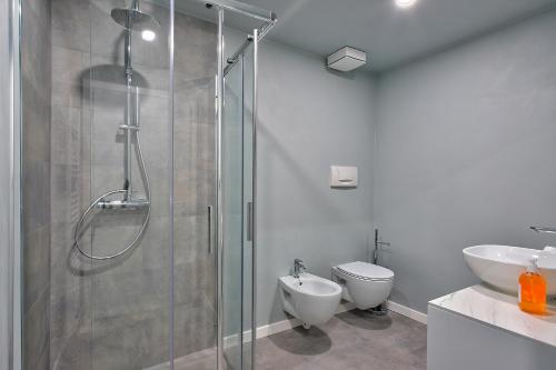 a bathroom with a shower and a toilet and a sink at Concilium in Trento
