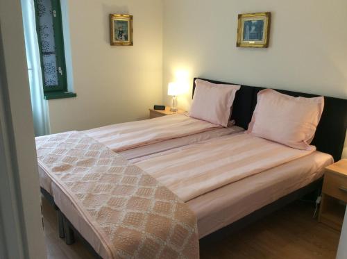 A bed or beds in a room at Biro Apartman