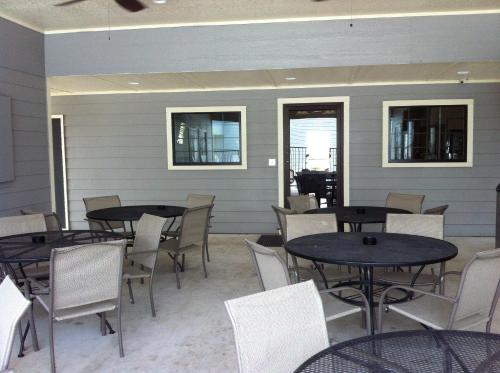 a group of tables and chairs in a patio at Southern Inn and Suites Yorktown in Yorktown