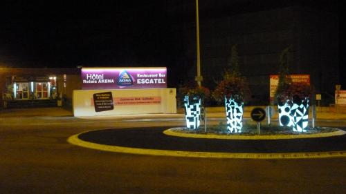 a roundabout in the middle of a street at night at Cit'Hotel Escatel in Mâcon