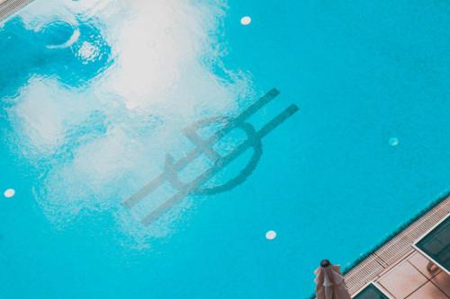 a reflection of a person in a swimming pool at Hotel Gaby in Rimini